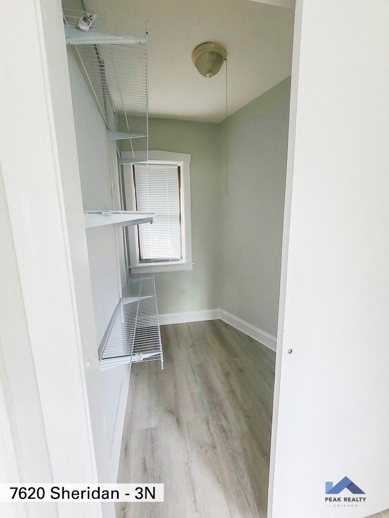 an empty room with a closet and a window