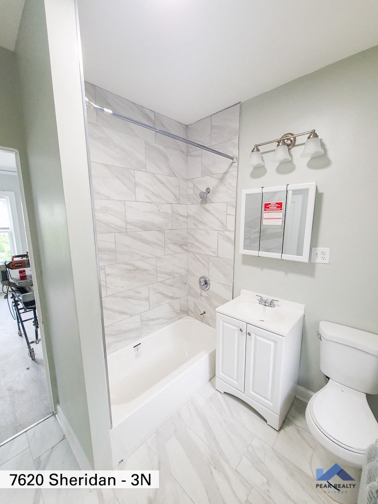 an image of a bathroom with a shower toilet and sink