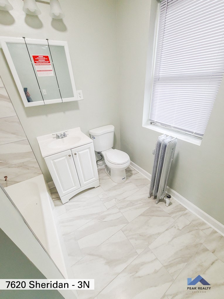 an image of a bathroom with a toilet and a sink