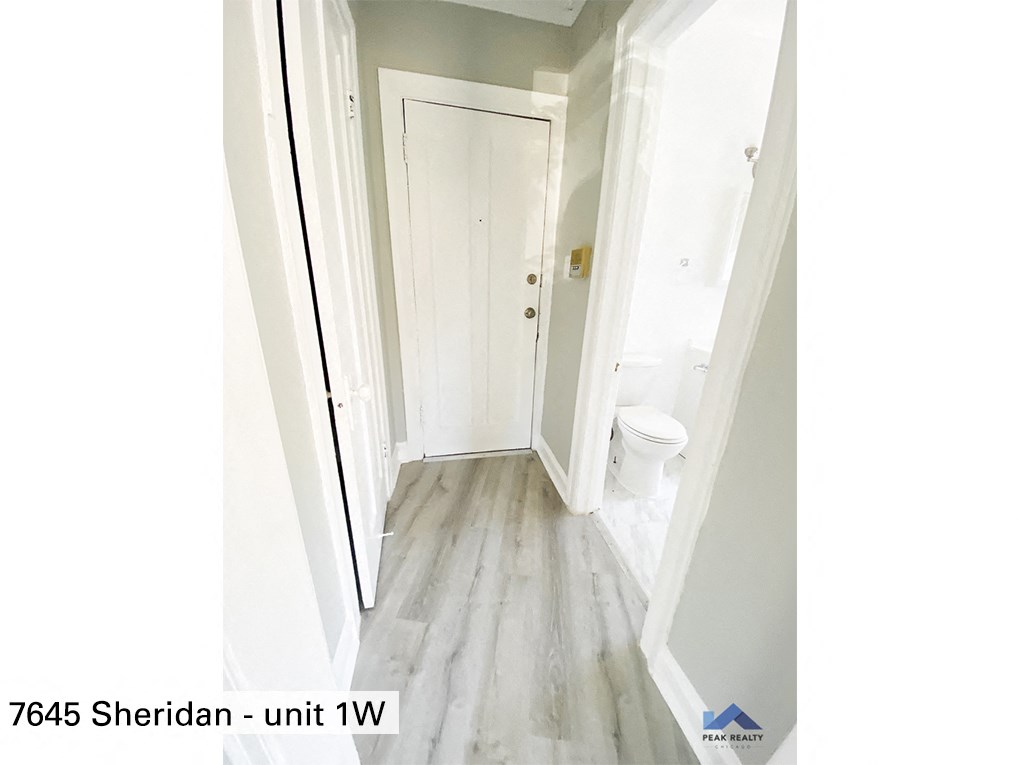 a view of the hallway from the bottom of the stairs looking up to the bathroom