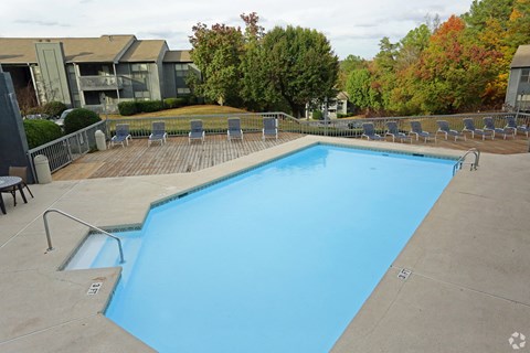 a swimming pool with chairs around it at a hotel
