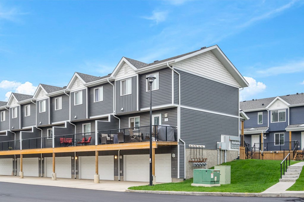 a row of houses with grey siding