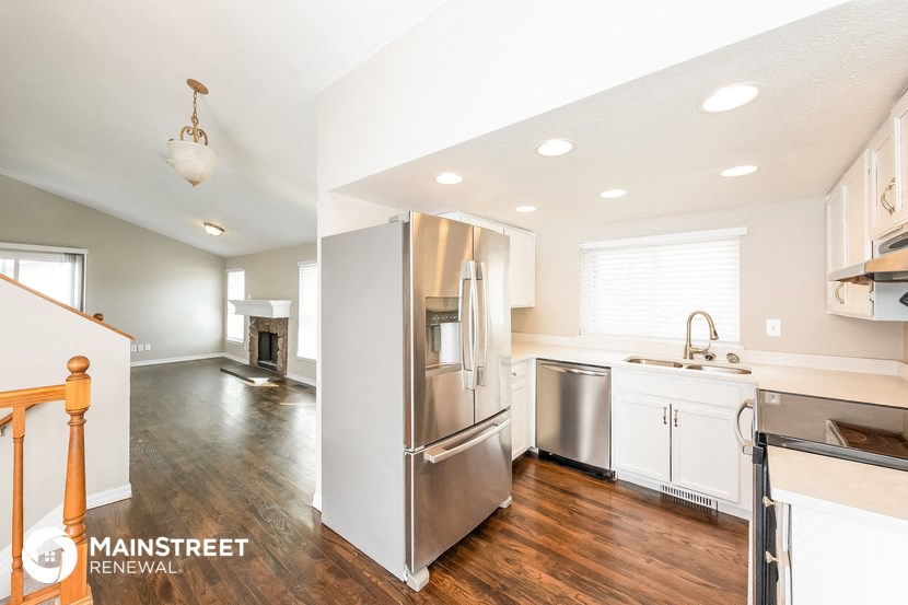 a renovated kitchen with stainless steel appliances and white cabinets