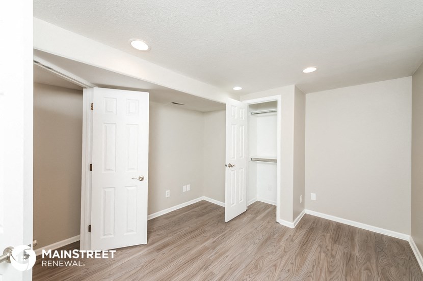 the second bedroom is spacious and has a large closet and hardwood flooring