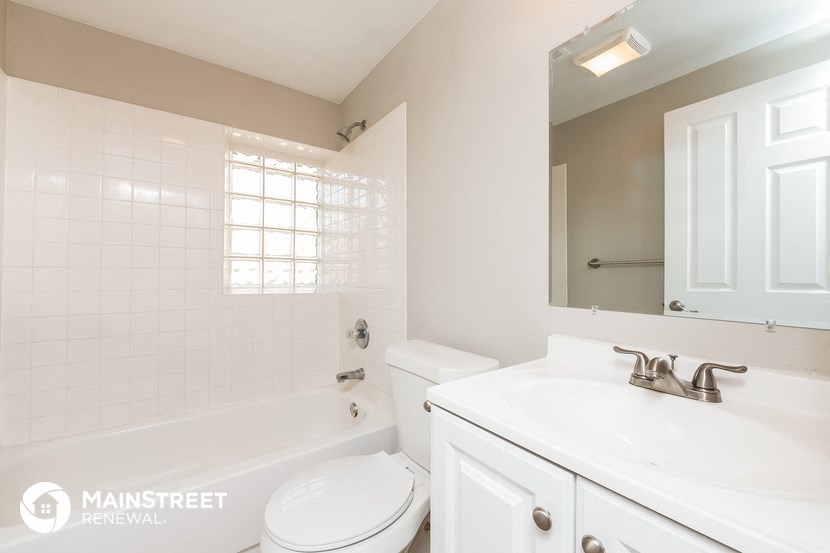 a bathroom with a sink toilet and tub and a mirror