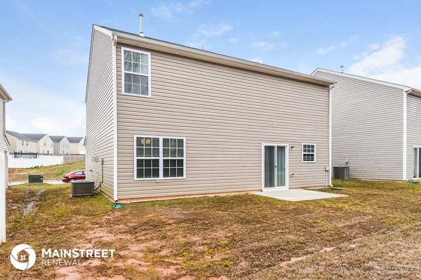 a white house with a yard in front of it