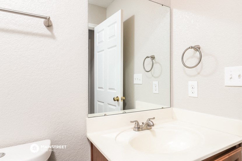 a bathroom with a sink and a mirror