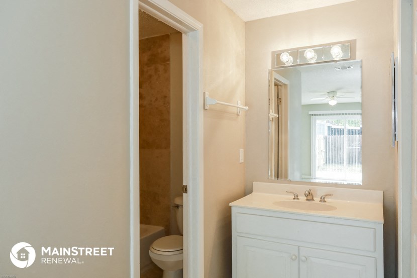 a bathroom with a sink and a mirror and a toilet