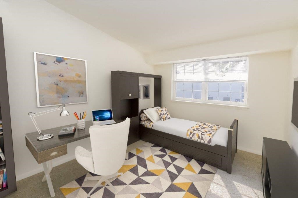 a bedroom with a bed and a desk with a chair