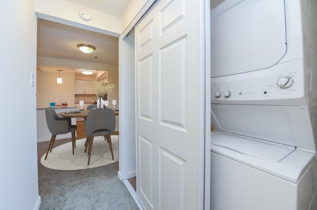 a washer and dryer in a kitchen next to a dining room