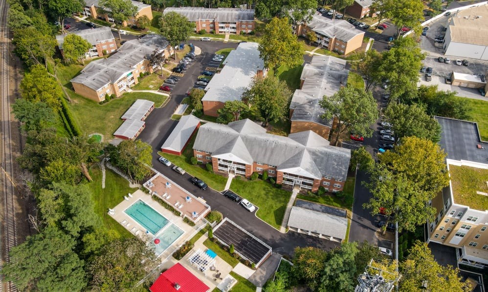 an aerial view of a neighborhood with houses and a pool