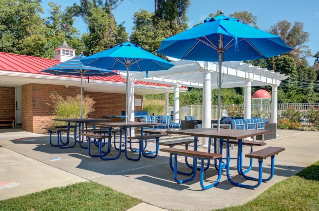 our picnic tables have umbrellas and chairs    and benches