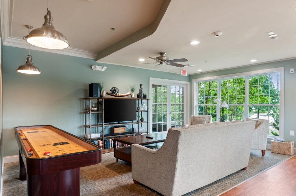 a living room with a pool table and a television