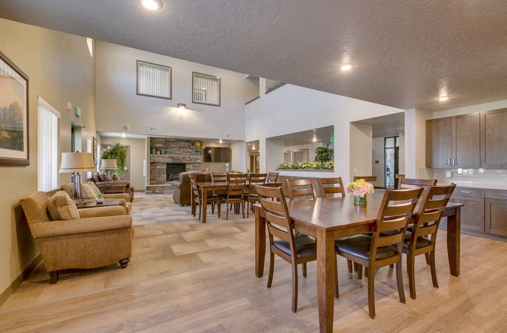 a living room and dining room with a table and chairs