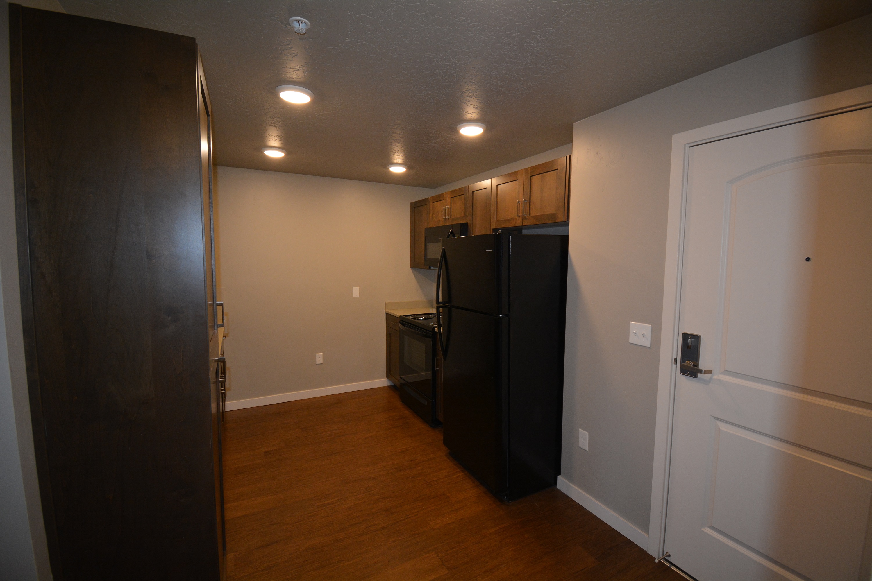 Image of a refrigerator, a stove, a microwave and some cabinets