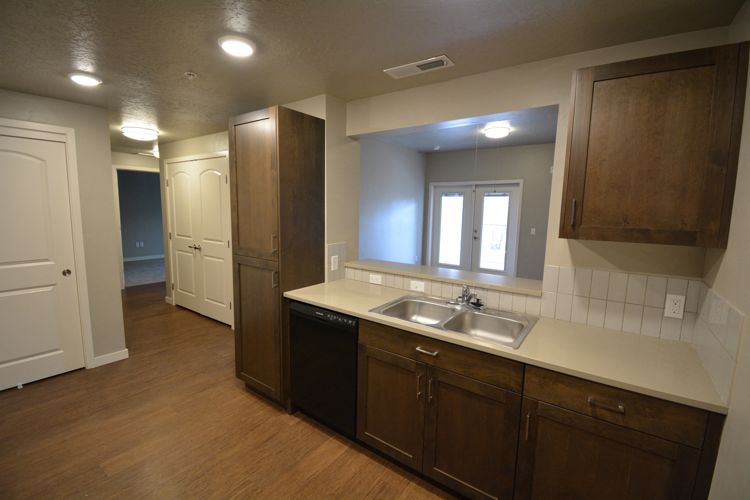 Image of sink, dishwasher, cabinets and counter space