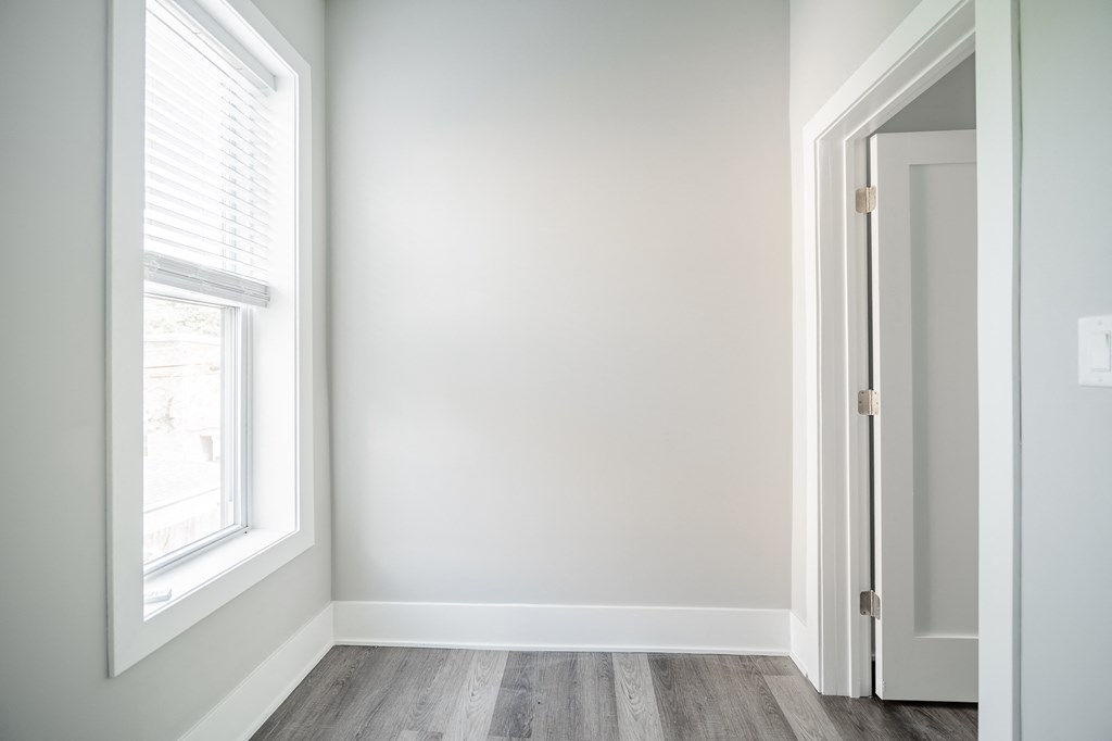 an empty room with a door and a window