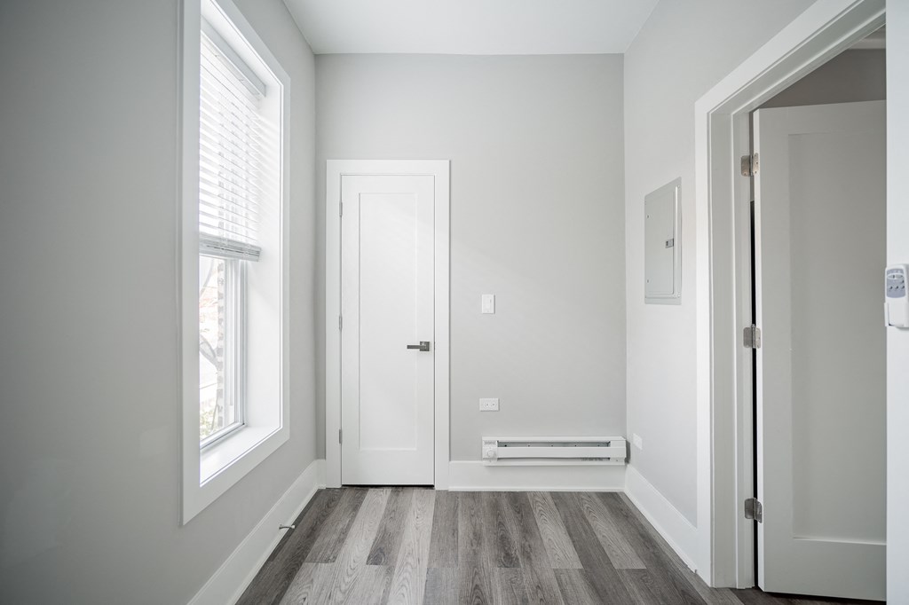 an empty room with a door and a window