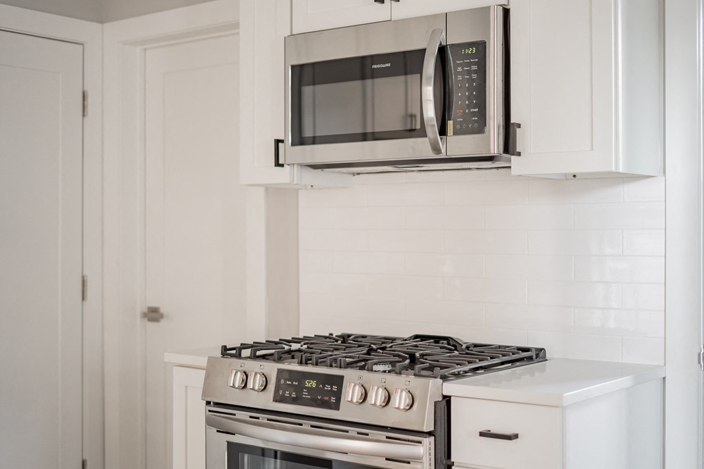 a small kitchen with a stove and a microwave