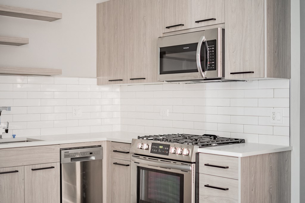 a kitchen with stainless steel appliances and wooden cabinets