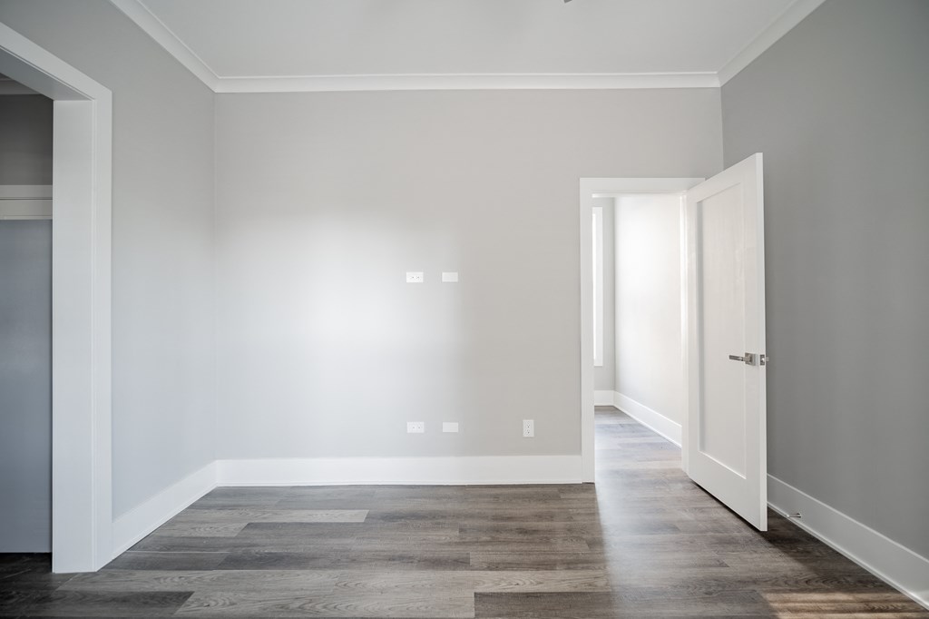 an empty room with white walls and a door