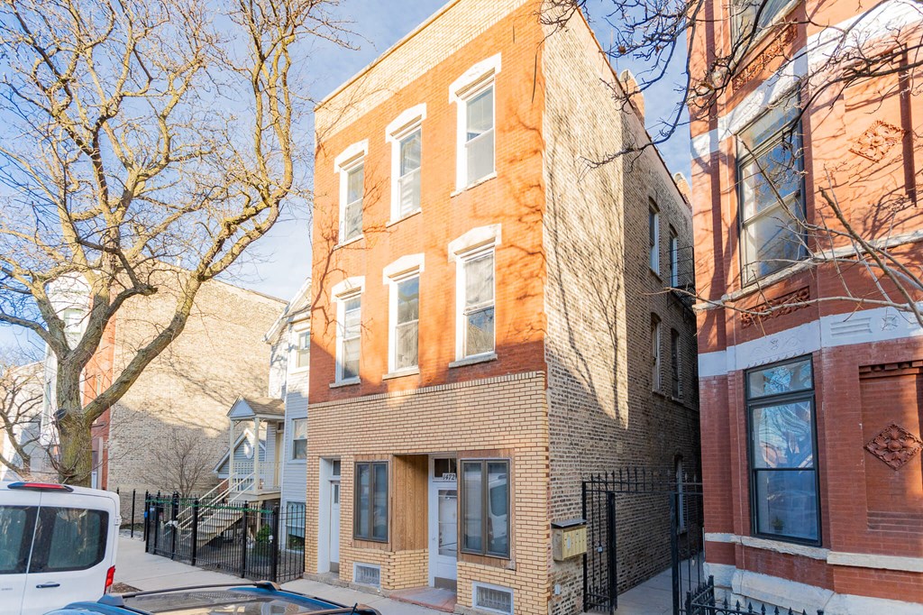 a brick building with a van parked in front of it