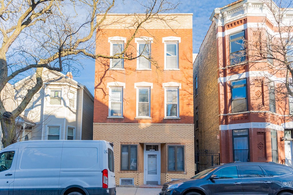 a white van parked in front of a brick building