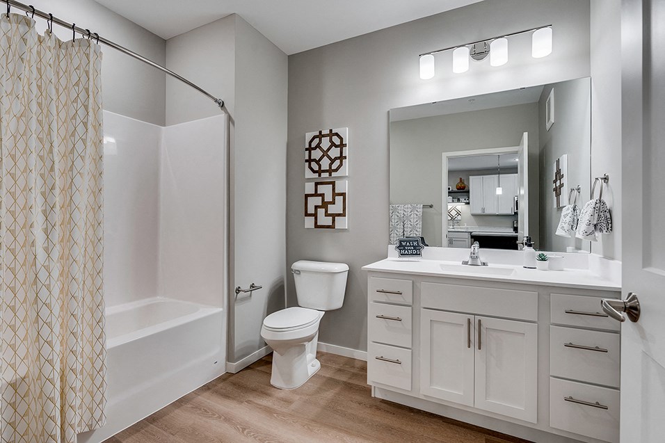 a bathroom with a shower and a sink and a toilet