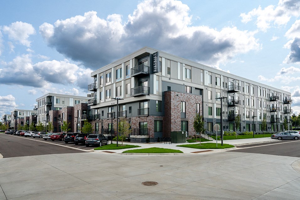 a large apartment building on the corner of a city street