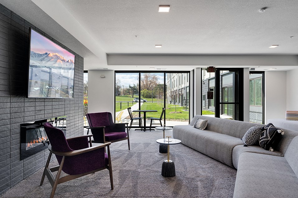 a living room with a couch and chairs and a fireplace