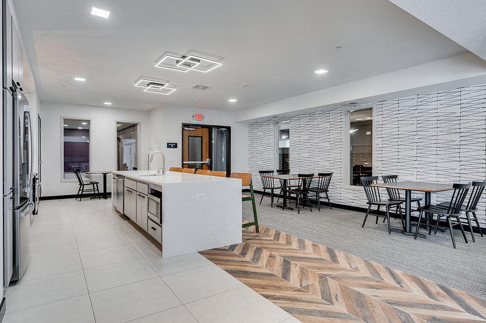 an open kitchen and dining area with a table and chairs