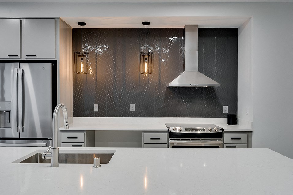 a kitchen with a white counter top and a refrigerator