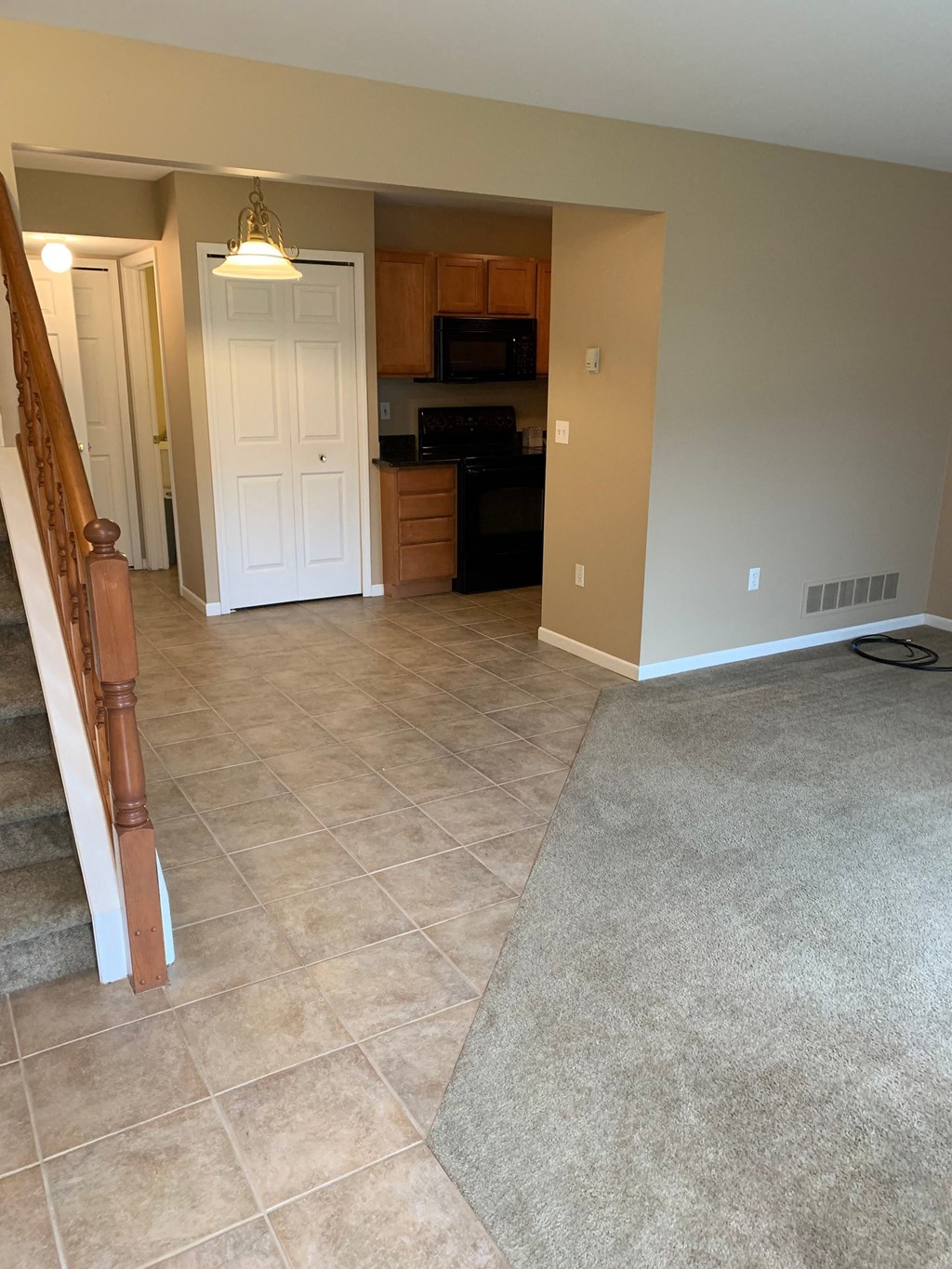 a kitchen and a living room with tile flooring