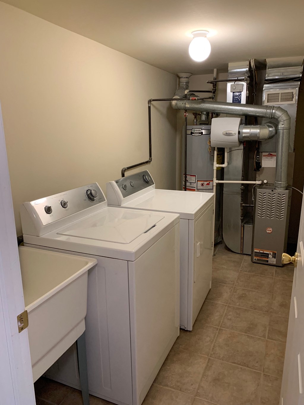 a laundry room with two washes and a dryer
