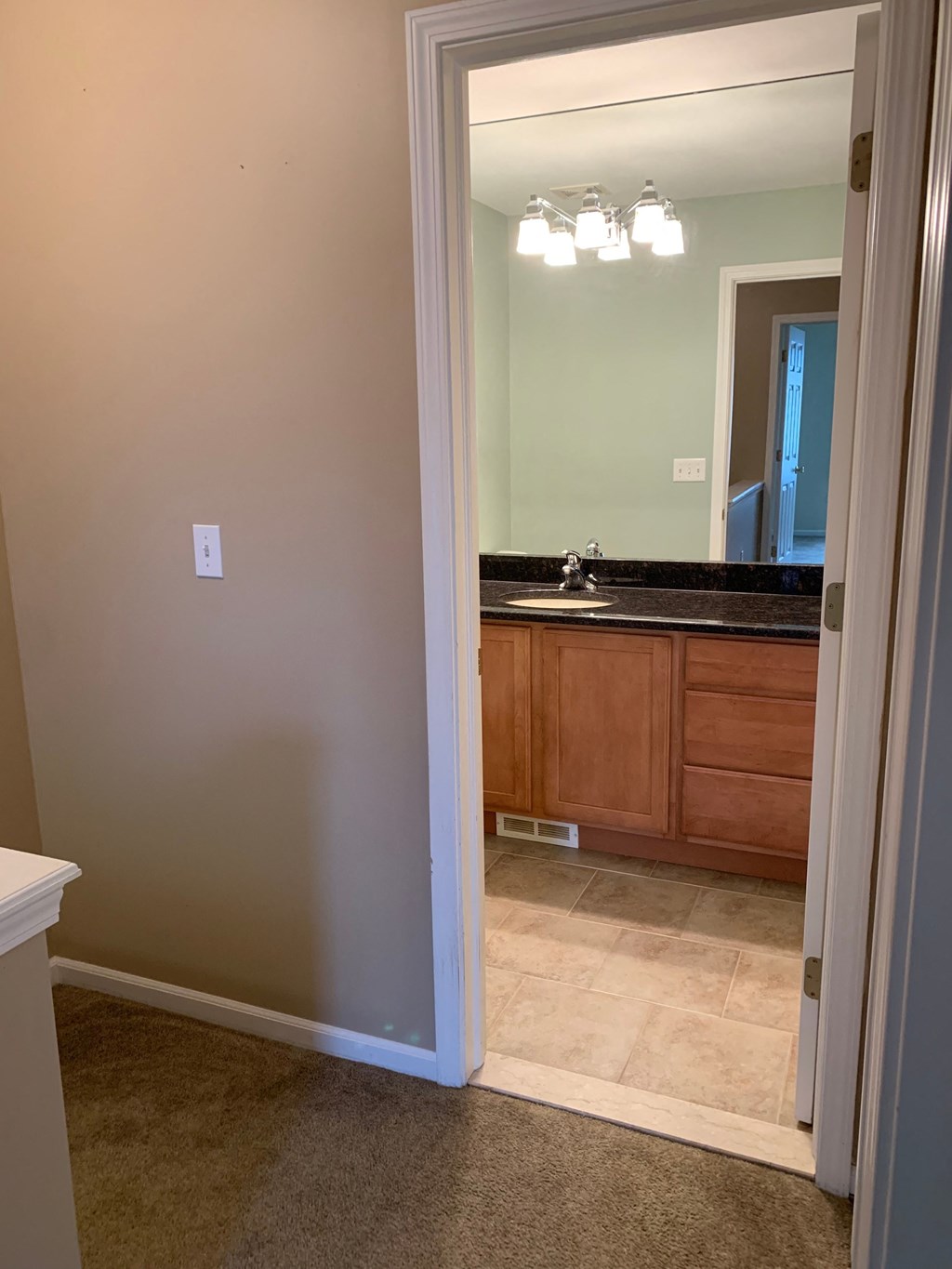a view of a bathroom with a sink and a mirror