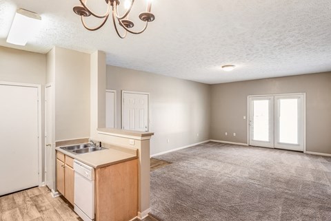 A kitchen area with a sink and a refrigerator.
