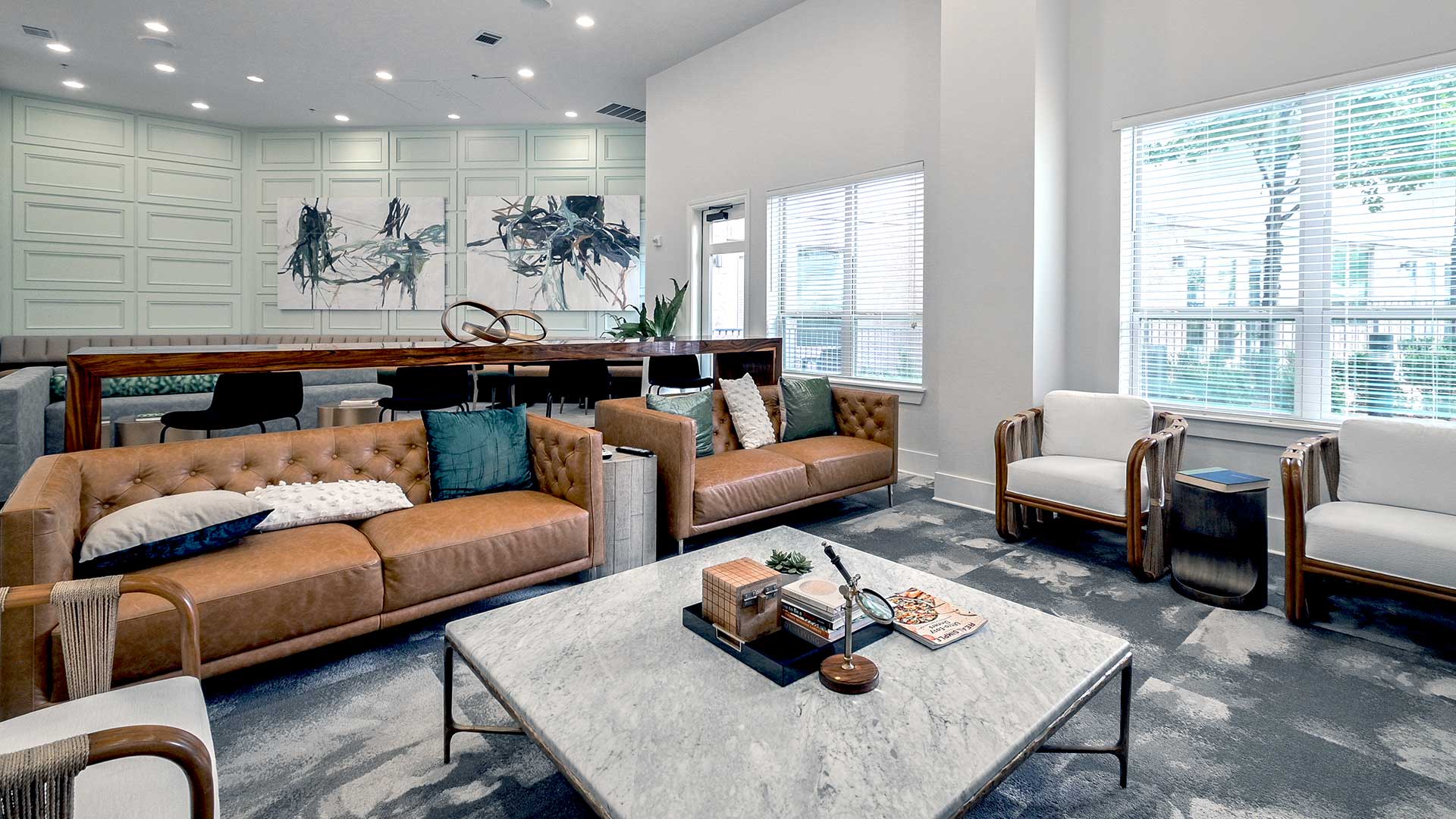 a living room with couches and chairs and a table