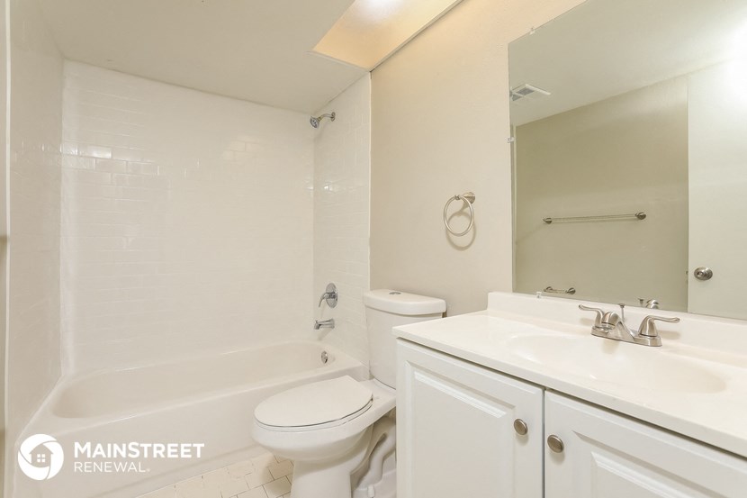 a white bathroom with a sink toilet and tub