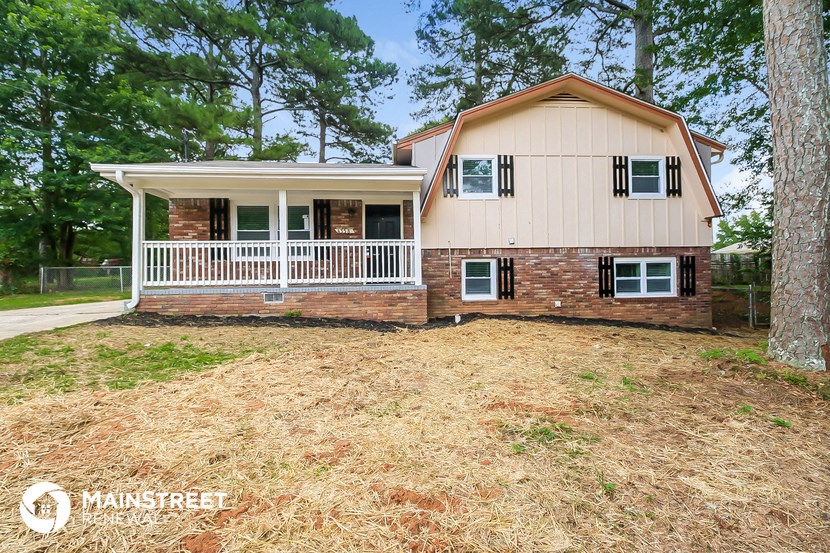 a small house with a white roof and a white porch