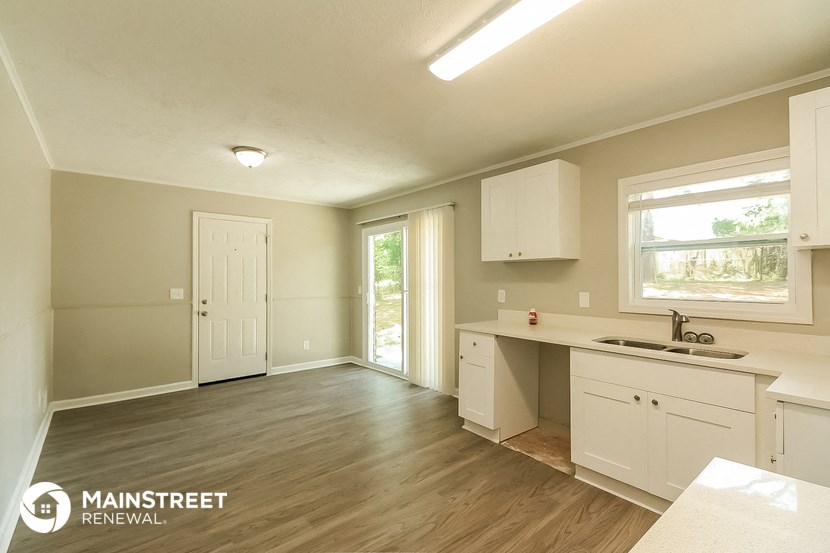 the kitchen and living room of a renovated house