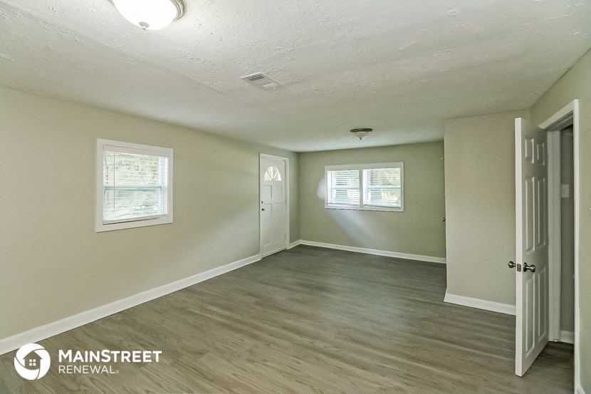 the living room and dining room of a renovated house