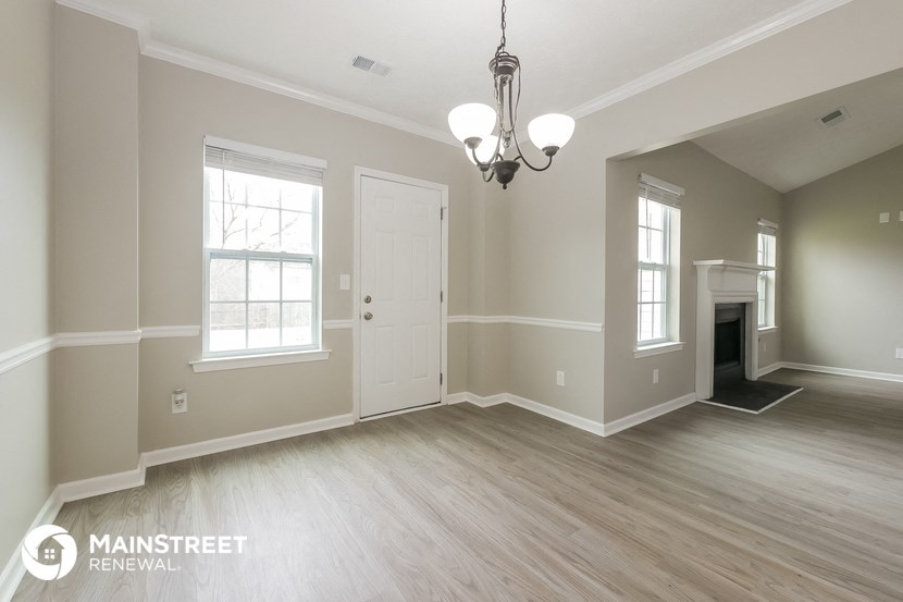 the living room of a new home with wood floors and a fireplace