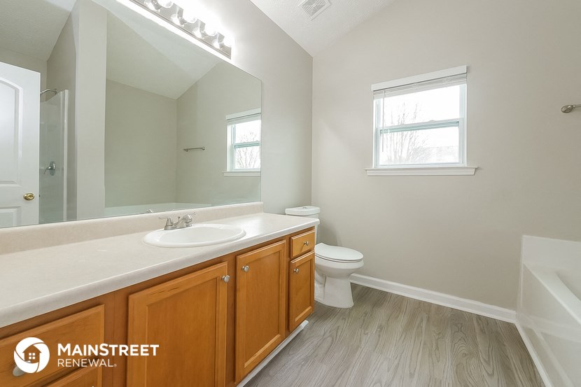 a bathroom with a sink and a toilet and a mirror