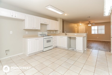 a kitchen with white cabinets and a stove and a sink