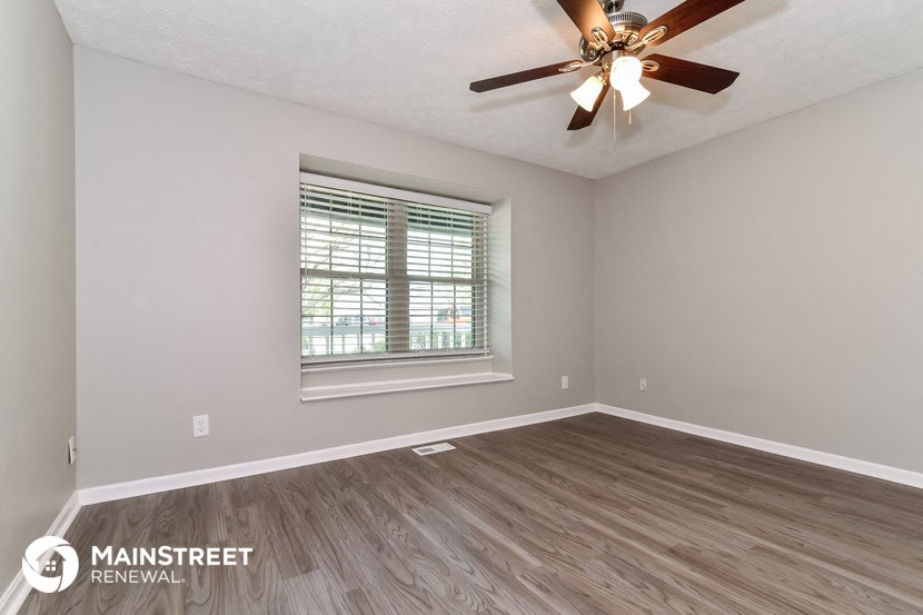 the living room of our two bedroom rental home atrium with a ceiling fan