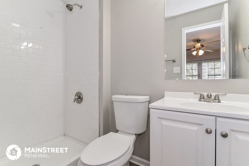a white bathroom with a toilet and a sink