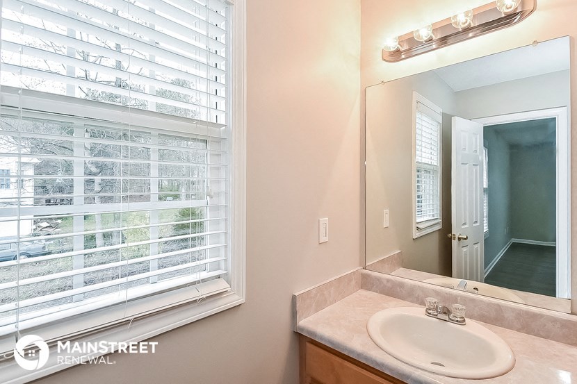 a bathroom with a sink and a large window