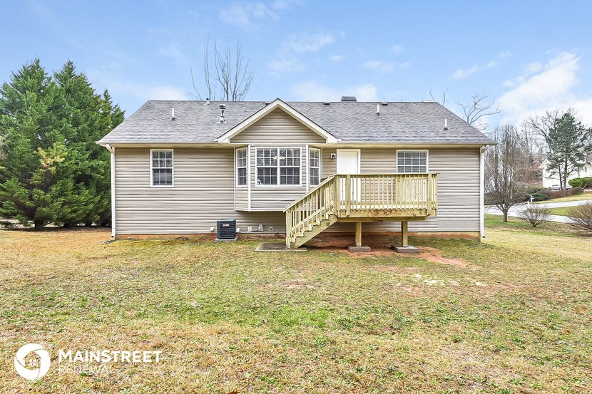 the front of a house with a porch and a deck