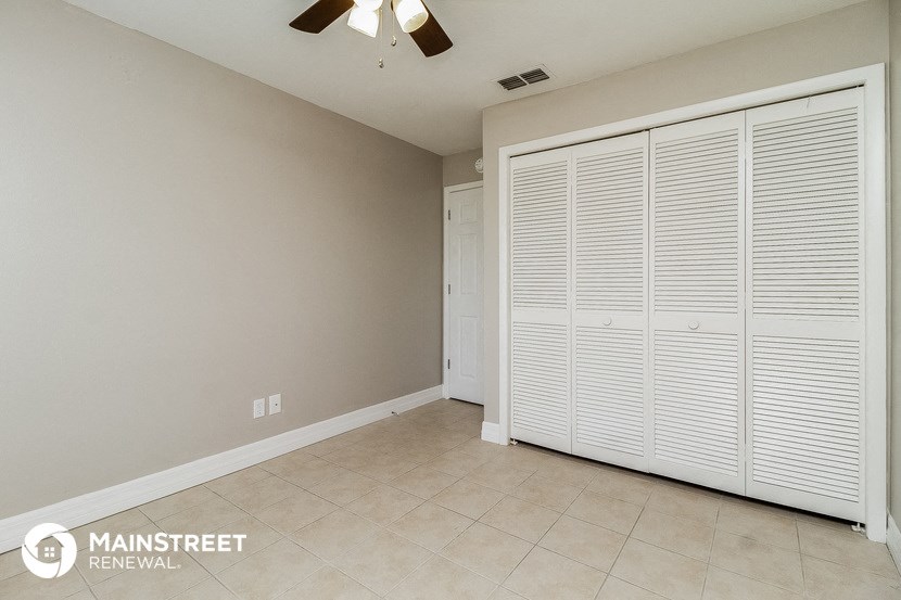 the master bedroom has a large closet and tile flooring