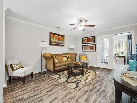 a living room with furniture and a ceiling fan
